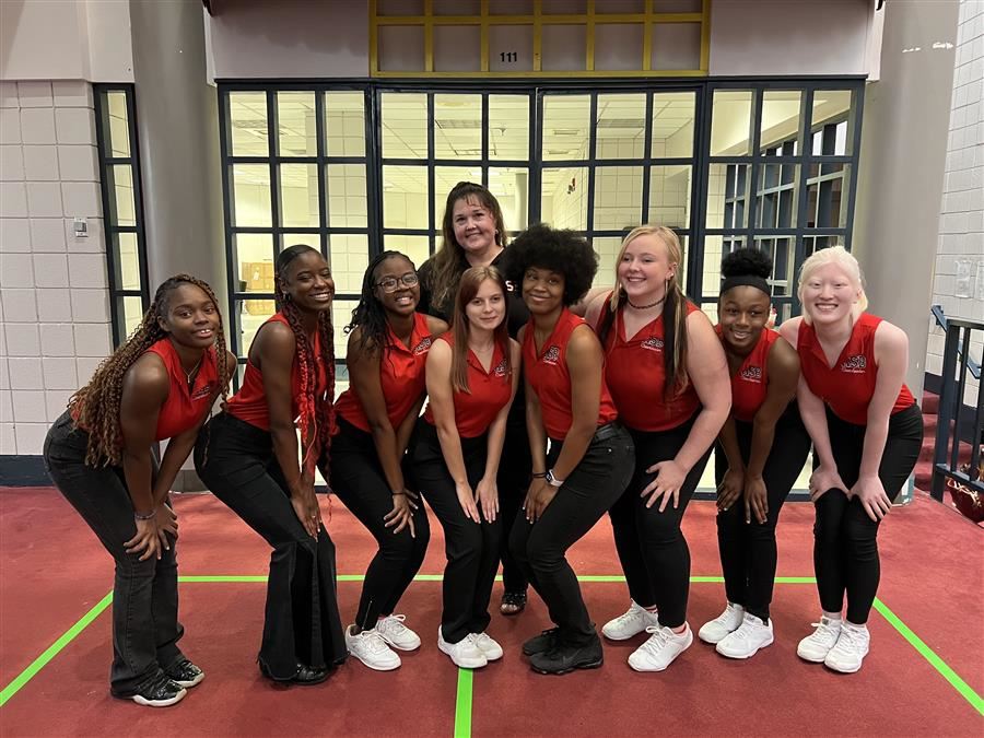  The ASB Cheerleading Team pose as a group and smile to the camera.